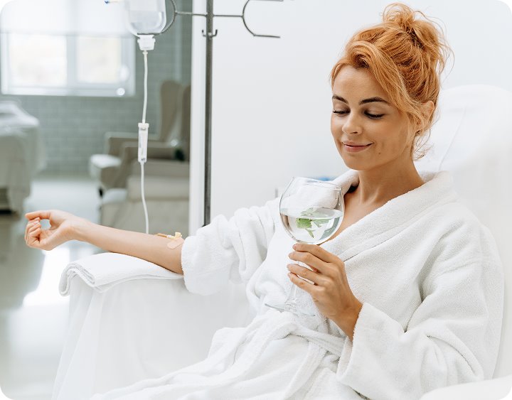 A client relaxing with a drink during an infusion at Better Life Infusions