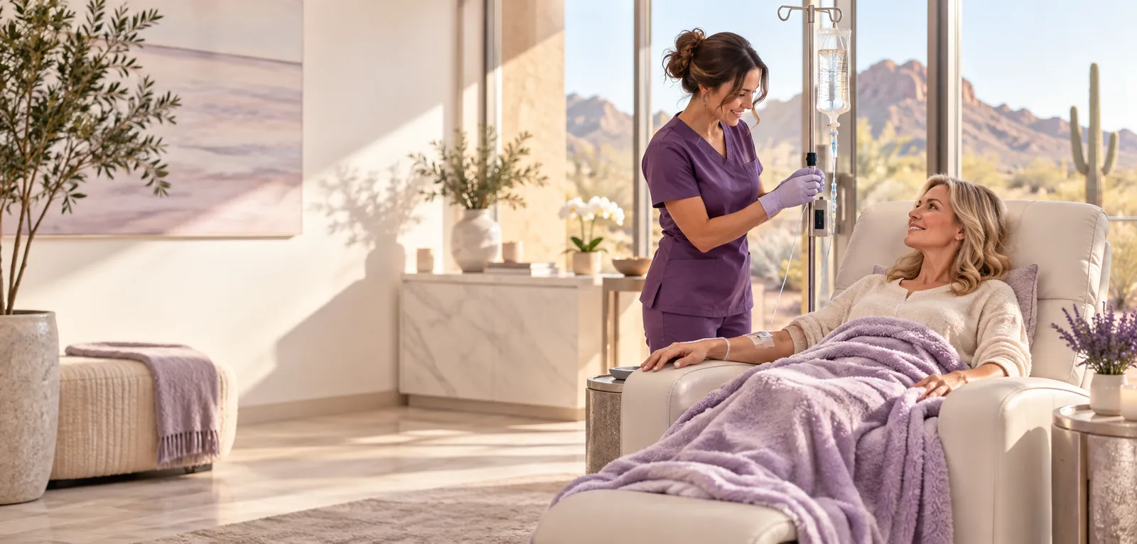 A client resting under a lavender blanket during a Better Healing IV session while a nurse adjusts the line in Mesa, Arizona