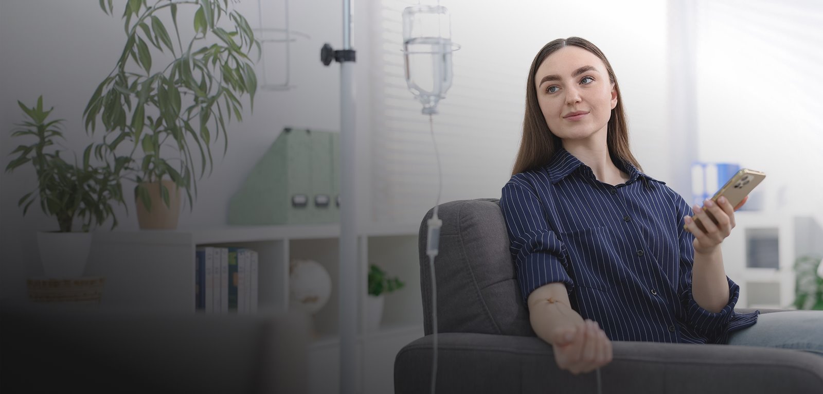 A client relaxing on a sofa during an IV hydration session