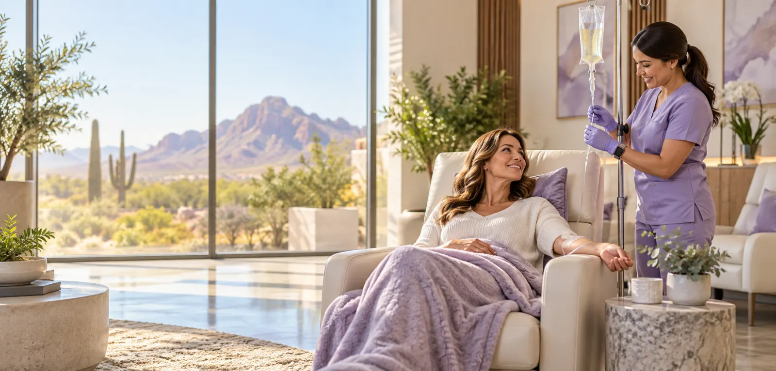 A client receiving a Life Boost IV therapy drip while a Better Life Infusions nurse adjusts the line in Mesa, Arizona