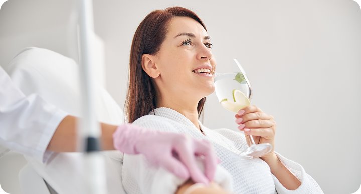 Client enjoying a drink during an infusion session