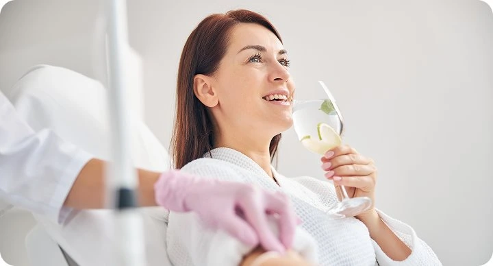 Client enjoying a drink during an infusion session